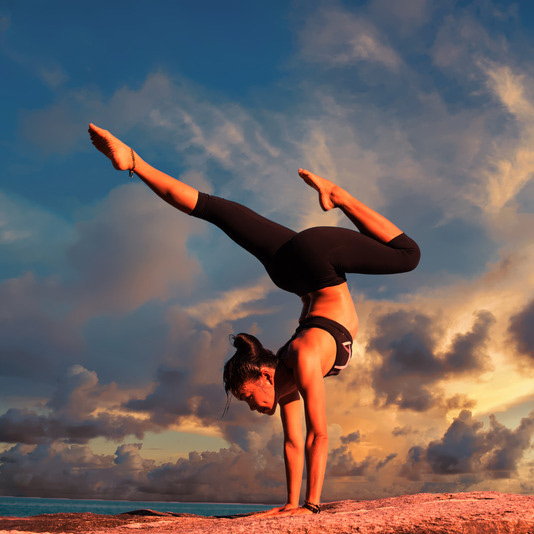 Wild Workouts & Wellness offers fitness tips: member does handstand outside. 