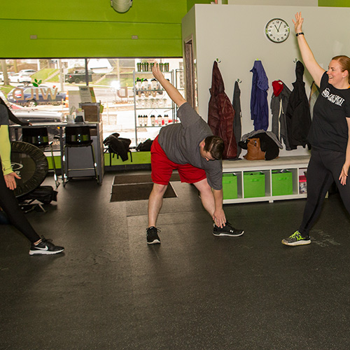 Small group class stretching at Wild Workouts & Wellness Bayview, WI.